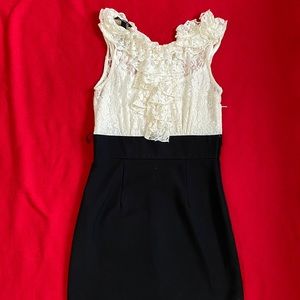 Cream and black dress with lace overlay.